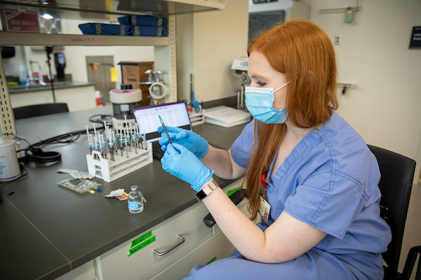 Hayley Schrock, M4, drawing up syringes of fentanyl for use in von Frey tests.